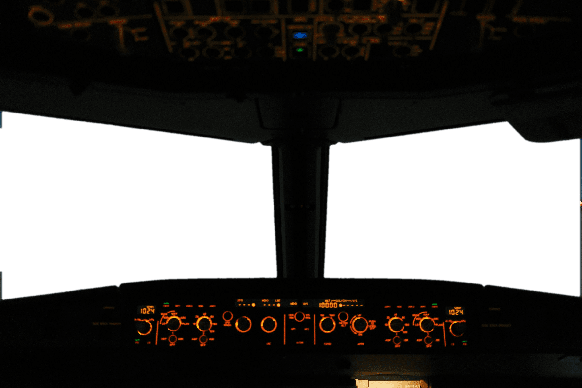 The flight deck of an airliner at dusk, instruments glowing